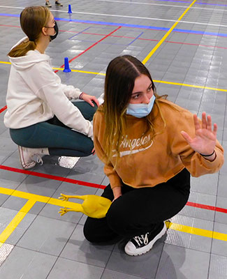 Students play Help Me Tag, some with rubber chickens!