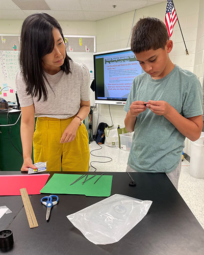 Pi-Sui Hsu works with a summer camp participant at RESA.