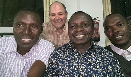 Cohen and new friends at Tanzania’s Etaro secondary school: headmaster Jacob and teachers Boniphace and Moses.