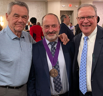 Paul Wright (center), flanked by Tom Martinek of the University of North Carolina at Greensboro (left) and Tom Templin of the University of Michigan (right).