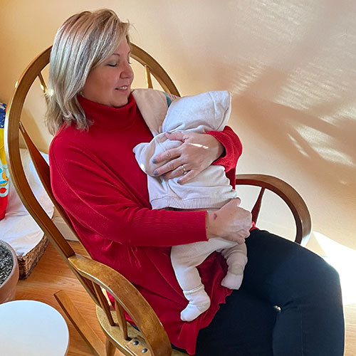 Grandma Jenny cuddles baby Arthur.