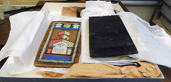 A wooden diploma from an Islamic school and an old Korean block press.