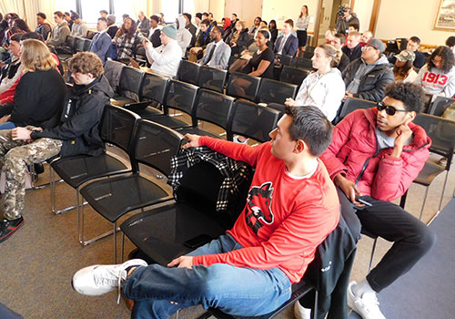 Panel discussion audience members listen to the stories of Project FLEX.