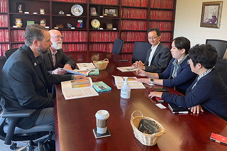 Han-Yu Wu (right) and Min-Ju Liu in Humboldt Park. meet with (from left) David Walker, Bill Pitney and Wei-Chen Hung.
