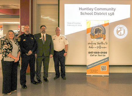 Lombard gathers with local officials at her State of Huntley address.