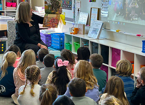 Once a teacher, always a teacher: Jessica Lombard reads to children.