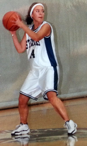 A young Jenn Jacobs plays basketball.