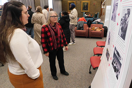 Teslin Kerley explains her group’s poster to Suzanne Degges-White, chair of the Department of Counseling and Higher Education.