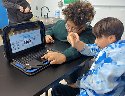St. Mary sixth-grade students Will (left) and Leo (right) conduct AI training and game development using the Machine Learning for Kids website.