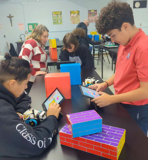 Eighth-grade students attempt to program LEGO car movement commands independently.