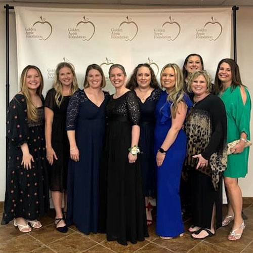 Erin Anderson (fourth from left) celebrates Golden Apples.