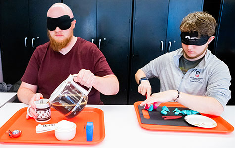 NIU Visual Disabilities students practice skills while wearing sleep-shades.