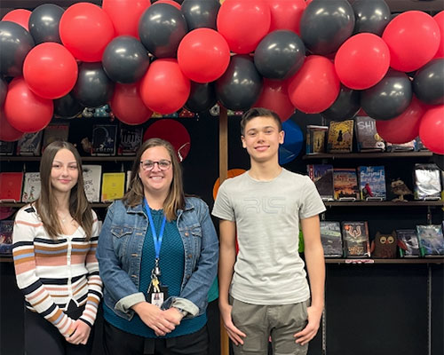 Gerrie Ausila welcomes two Albright Middle School students to her office.
