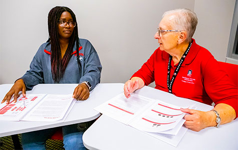 Mary Gardner discusses Jerry L. Johns Literacy Clinic operations with an NIU student-tutor. 