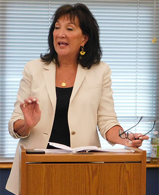 Becky Surber speaks at an August 2022 completion ceremony for Rockford Principal Residency Program graduates.