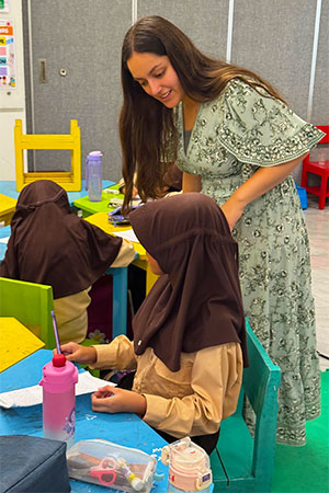 Daisy Cruz checks in with students.