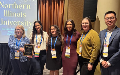 Jenna Alvarez (third from right), president of North Central ACES, congratulates Suzanne Degges-White, Dana Isawi, Yenitza Guzman, Melissa Fickling and Peitao Zhu.