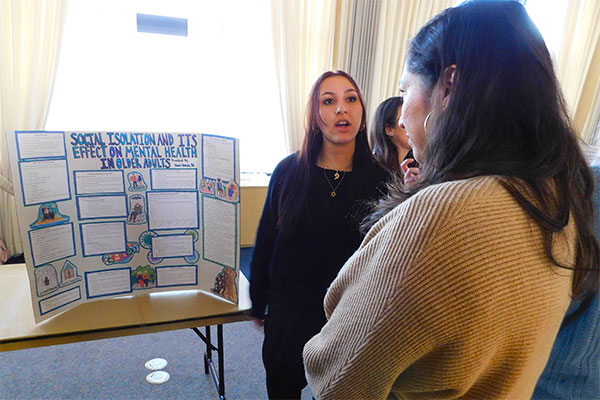 Sherri Wehde (left) presents her poster.