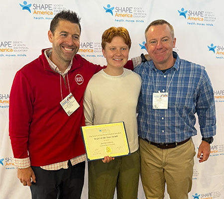 Zach Wahl-Alexander and Jim Ressler celebrate with Juel Mecklenburg, SHAPE America Major of the Year.