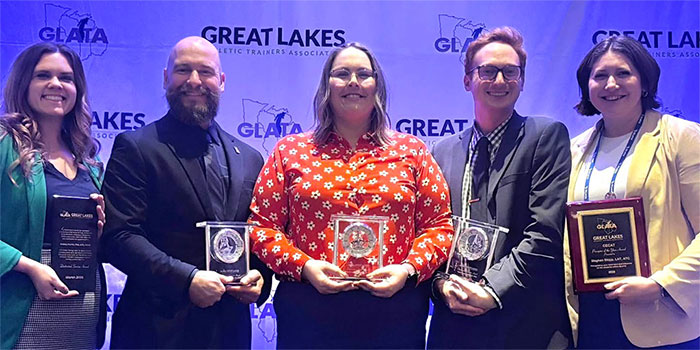 Nicholas Grahovec (second from left) and Tyler Wood (second from right) at the GLATA Annual Meeting and Symposium, held March 11 through March 13 in Wheeling, Illinois.